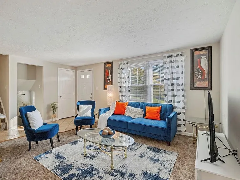 Well-appointed living room with a full seating set, large window, and media spaceideal for relaxing or hosting.
