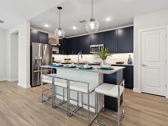 Kitchen with pendant lighting and floating shelves