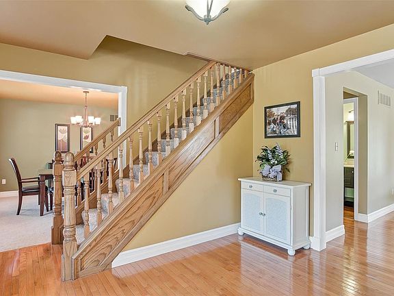 Large entry foyer, with hardwood floors that flow into the hall and main floor powder room