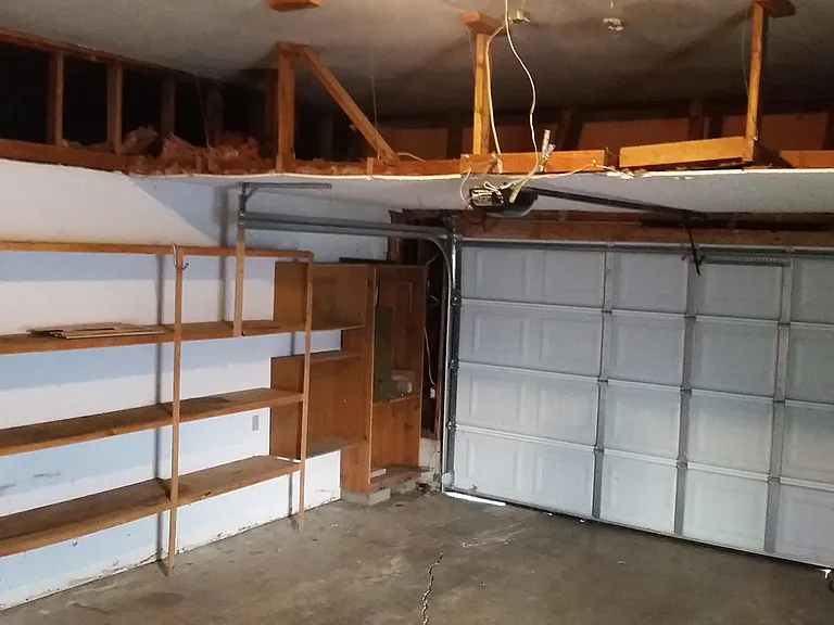 Two car garage has shelving for extra storage.