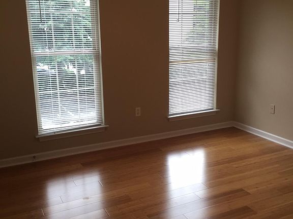 Large living room with bamboo flooring and lots of natural sun light