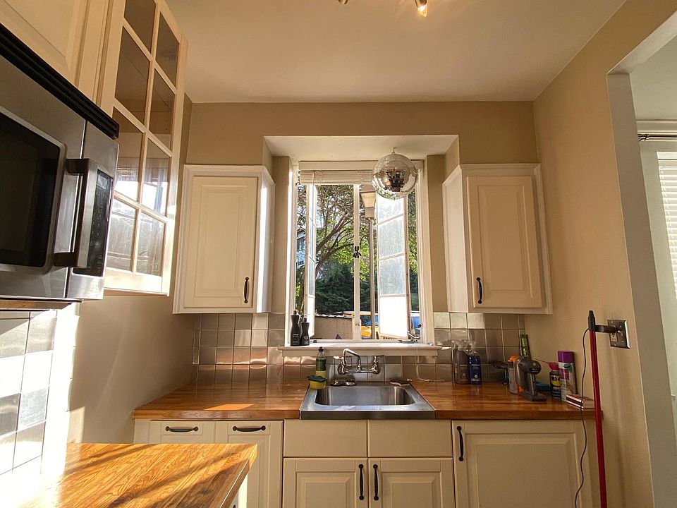 sunlit kitchen with new lighting and disco ball! you can open the casement windows as you please