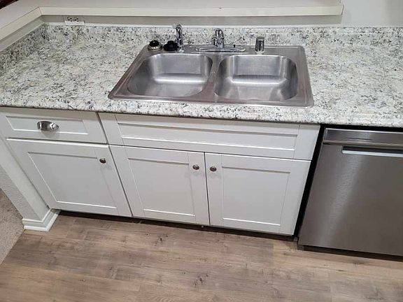Kitchen sink / counter: Dishwasher, garbage disposal, and floor picture 2