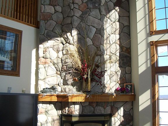 Living room fireplace with stones hand picked from Lake Superior