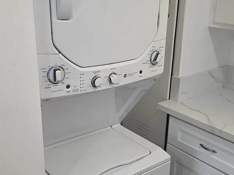 Newer wash dryer installed in kitchen