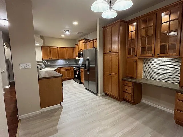 Second floor eat-in kitchen with brand new Stainless steel appliances, flooring and steel tile backsplash