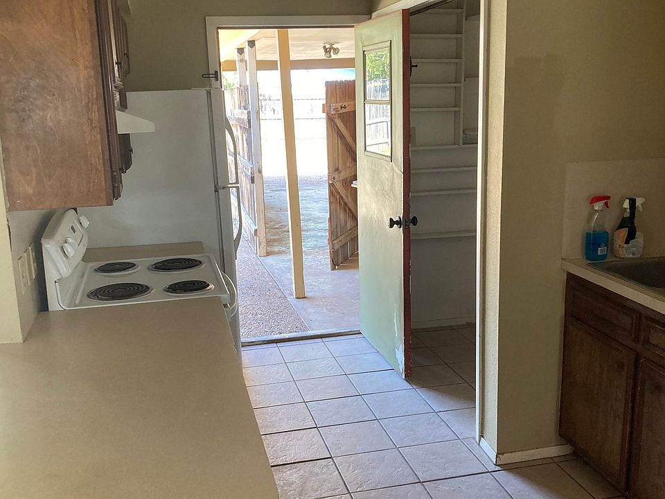 Alternate Kitchen View: Bright kitchen with ample counter space and easy access to the backyard.