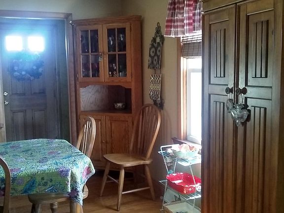 Dining room 15 Ft by 11 1/2 Ft Floating laminate floor. Oak table with extensions chairs and bench. A pantry cupboard and corner hutch.
