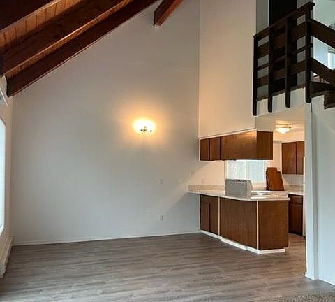 view of living and dining area with vaulted ceiling