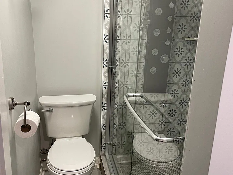 Lower Level bathroom boasts a custom tile shower and also a double sink.