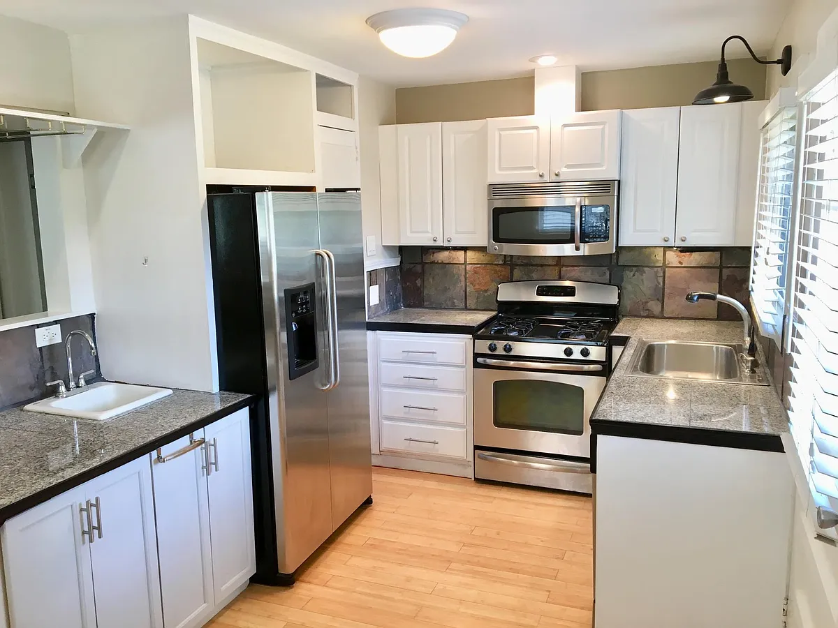 Kitchen has 2nd wet bar sink, Wine Glass Racks, Pantry, and Lots of Open Storage and Cabinets. - 1205 Ogilvie Dr NE