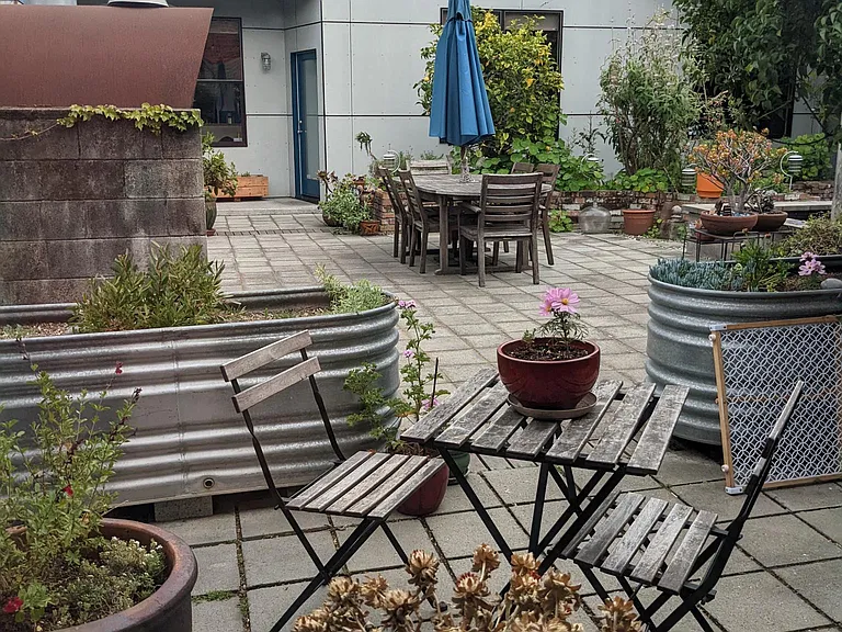 View out from private patio into BBQ/Grill area
