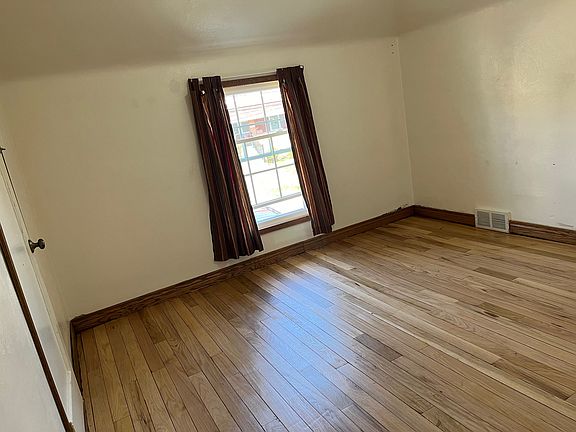 Medium bedroom with freshly restored hardwood