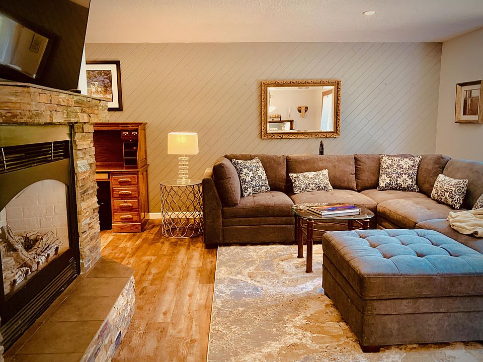 The main living room has a gas fireplace, a large smart TV on a swivel, and the most comfortable couch.