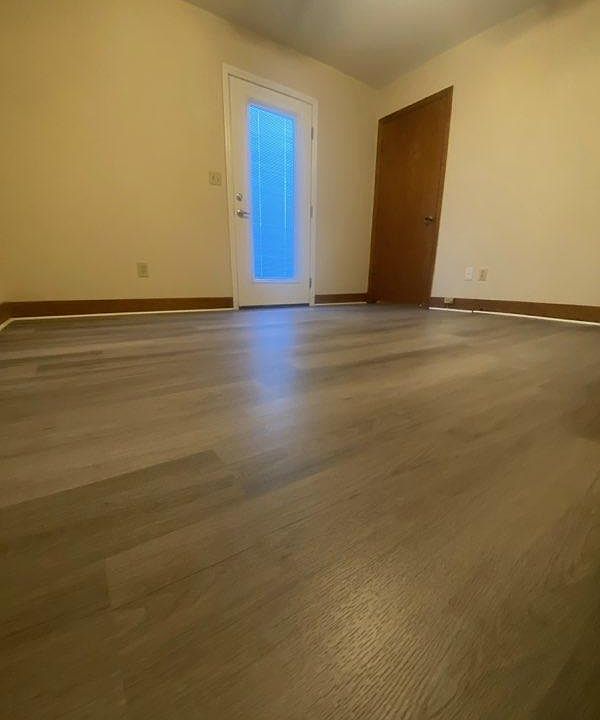 Downstairs bedroom. Door opens to small deck. Wood door opens to laundry room