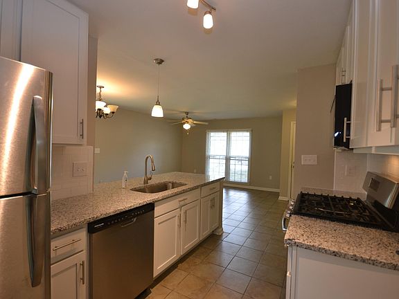 Gorgeous new kitchen with granite countertops opens to livin