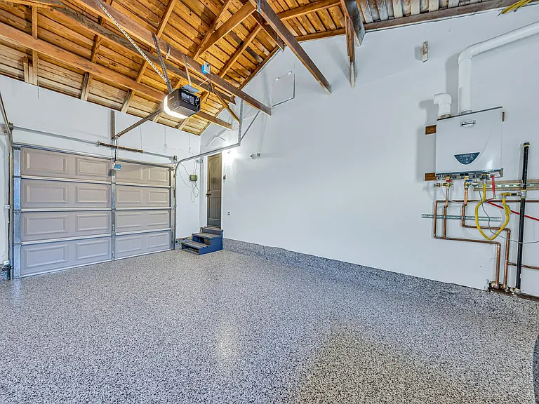 Private garage with tankless water heater & epoxy-coated floors.