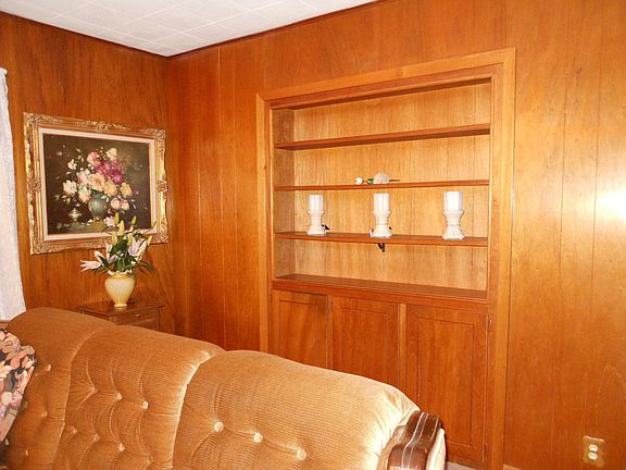 Beautiful Maple Paneling with custom bookshelves and storage in den