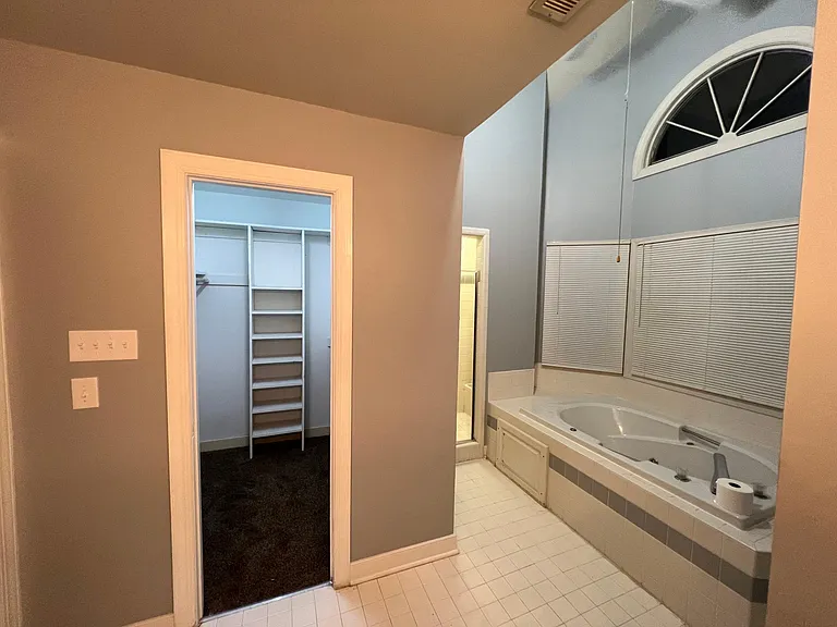 Master bathroom looking into walk in closet. Shower and tub on the right
