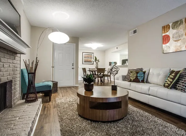 Spacious living room with wood-style flooring and open layout ideal for relaxing or entertaining.
