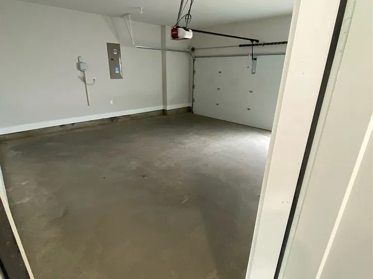 Two car garage has a car charger for your car and an entrance to the first floor.