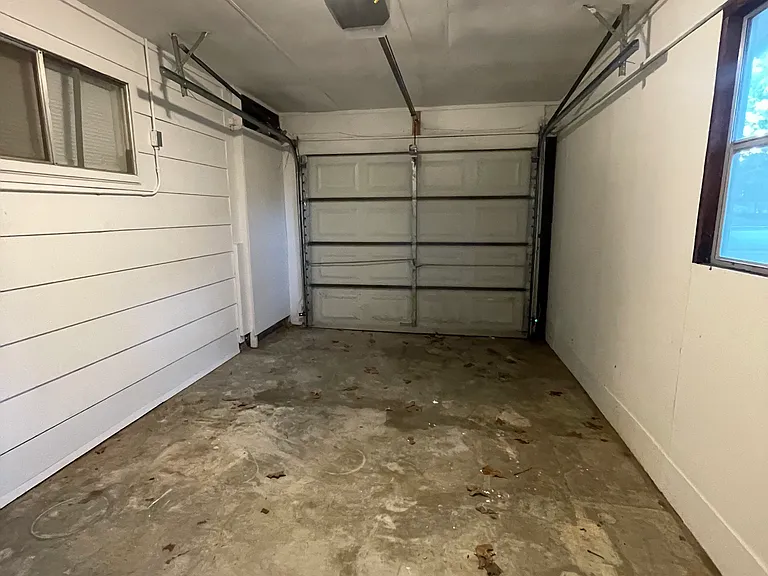 Enclosed carport with automatic door