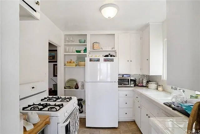 **Kitchen similar to photo. Photo is of upstairs unit kitchen and Ownership is installing a dishwasher in-unit