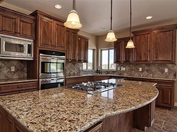 Gourmet kitchen with slab granite & gas cooktop