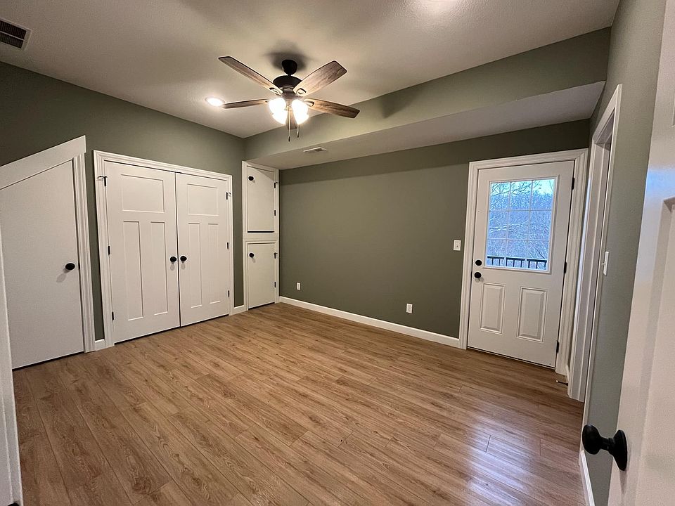 Main level first bedroom with additional storage nooks and double door to laundry room