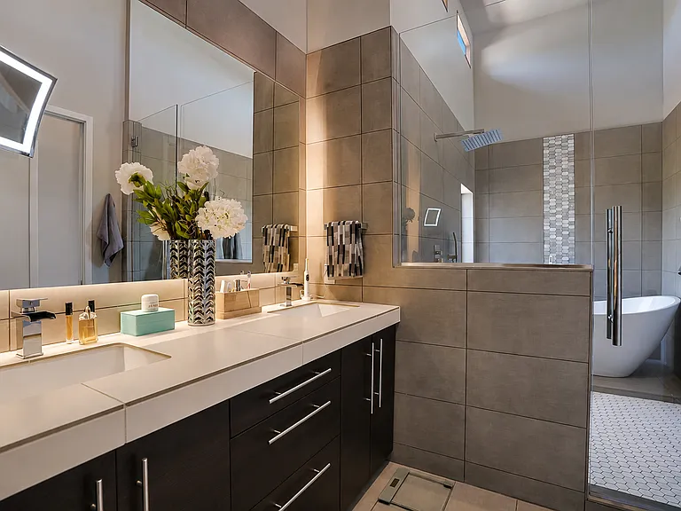 Large master bathroom with tub and shower in one area (glorious views from tub) plus heated floors which auto on w/timer and separate lavatory room (not in photo) with towel and sundries storage. Mirror is backlighted plus magnified mirror for close ups!