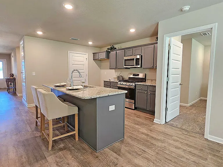 Open concept kitchen with island. 
Spacious pantry closet and in-wall cabinets. 
Appliances included: refrigerator, electric stove, microwave, and dishwasher.