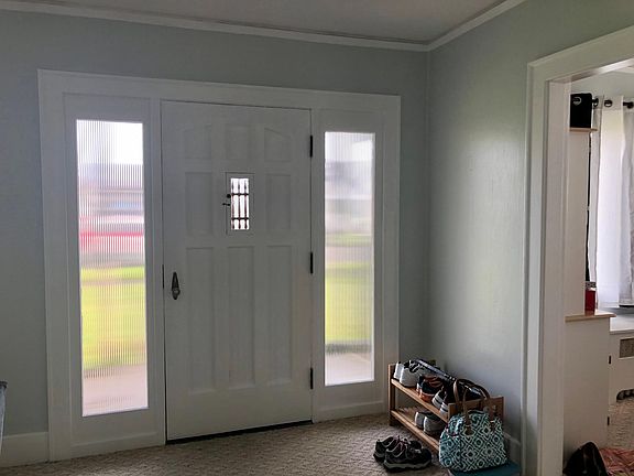 Classic Craftsman styling inside covered front porch.