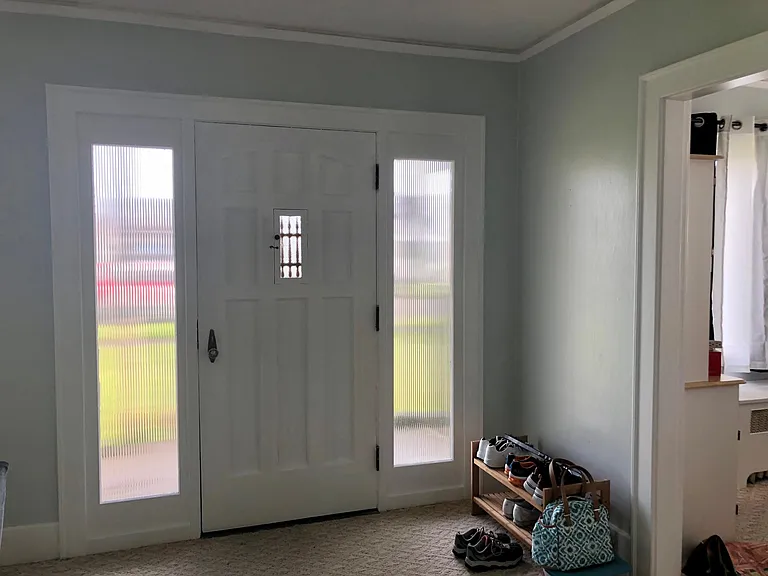 Classic Craftsman styling inside covered front porch.