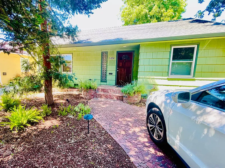 Front yard with off street parking, automatic sprinklers and lighting