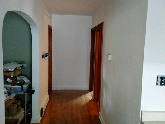 Hallway view from kitchen. One bedroom to the left, bathroom