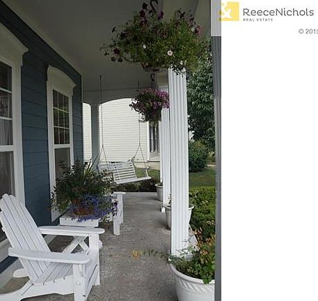 Beautiful covered porch, waiting for you to bring a book and glass of tea!