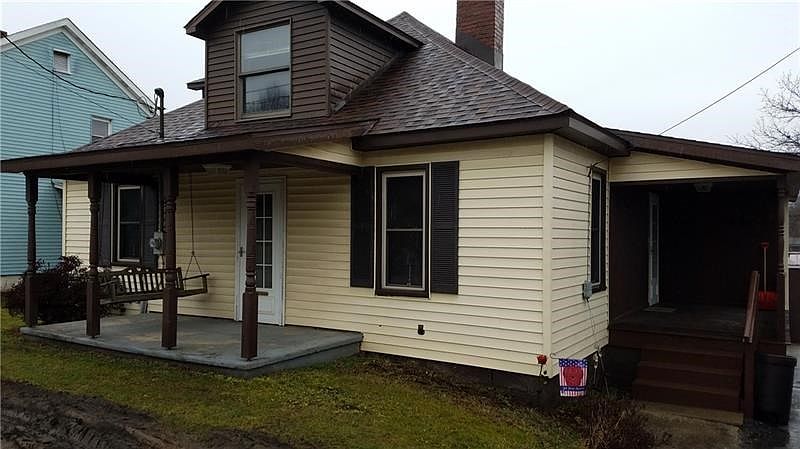 Cute story and half with front porch and full covered side porch