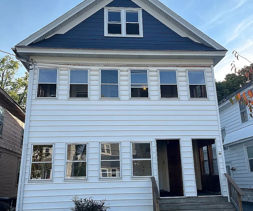 Front of the building, lower apartment, left door entrance to porch