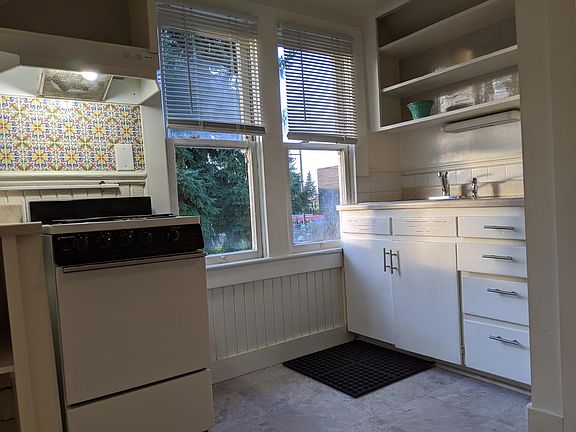 Kitchen is small but room for small table and chairs