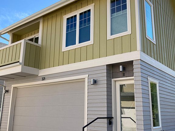 The unit is accessed through the glass door and up one flight of stairs above the garage of the unit A