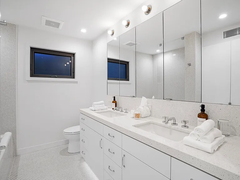 A refined vanity with designer finishes and plush towels.