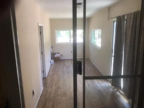 Looking into the bonus room with a big 5th bedroom on the left.