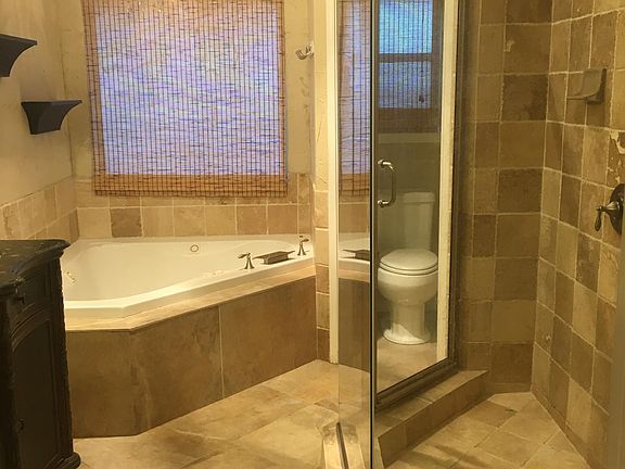 Custom master bathroom with triangular jetted tub.