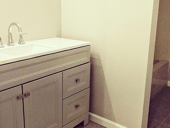 Master bathroom with updated vanity and mirror, new tile, and tub/shower combo.