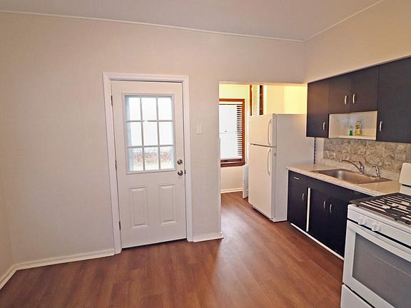 Kitchen with gas stove and refrigerator