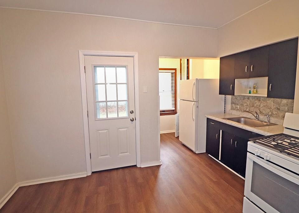 Kitchen with gas stove and refrigerator