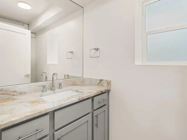 Downstairs Guest Bathroom. From the previous photo, walk down the small set of steps and you will find the laundry room and guest bathroom.