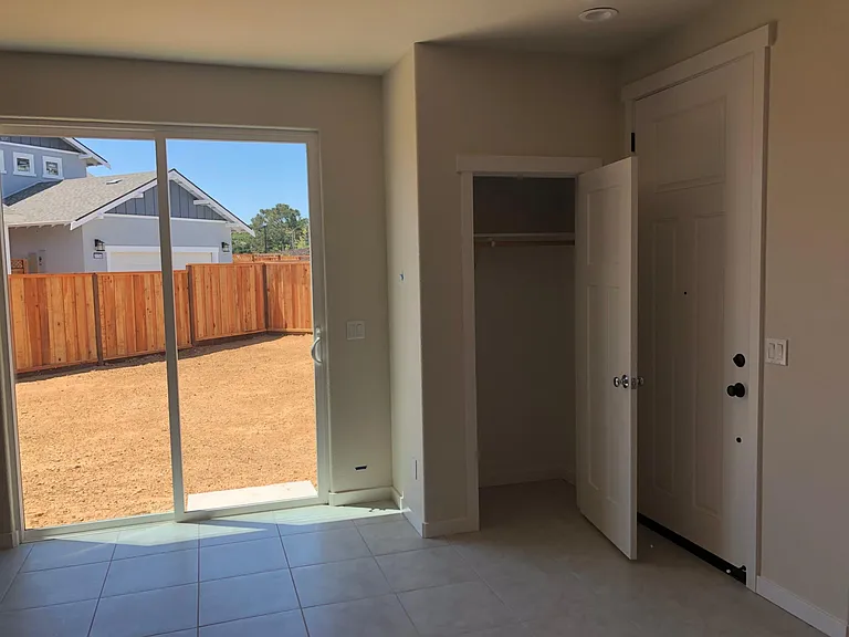 Dining room view to back yard with coat closet and front door view