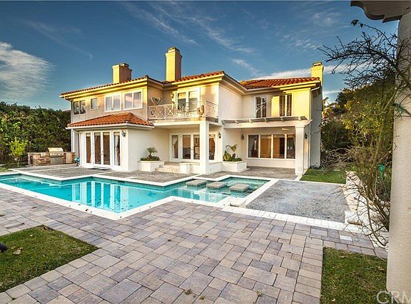 Pavers and in ground pool with a spa
