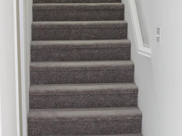 two tiered stairs for turn before second set. Half bath to the left.